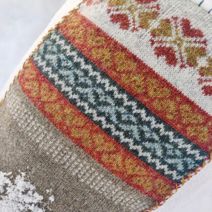 Knitted, patterned cushion made by hand in Sweden.
